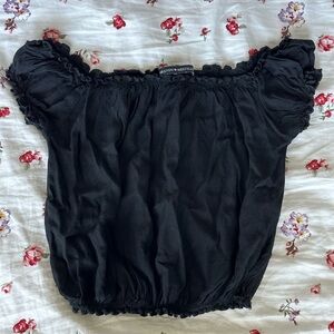 Black ruffled off-the-shoulder crop top from Brandy Melville